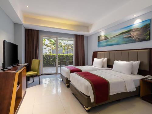 Postel nebo postele na pokoji v ubytování d'primahotel Kualanamu Airport Medan