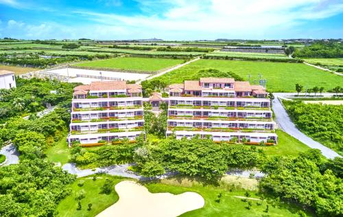 an aerial view of a resort building with a golf course at Shigira Bayside Suite Allamanda in Miyako-jima