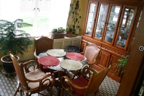a dining room with a table and chairs and a window at Tarry Here Mansion Bed & Breakfast in Salamanca