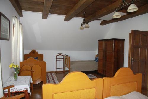 a living room with two beds and a bedroom at Árpád Ház in Alsónána