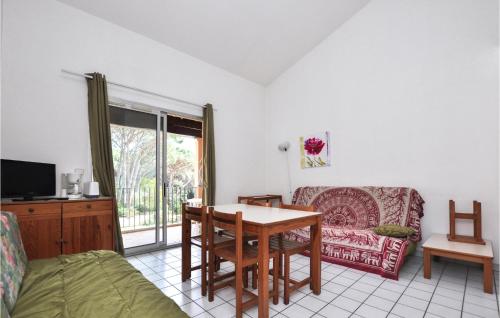 a living room with a table and a couch at Amazing Apartment In Sainte-Maxime in Sainte-Maxime