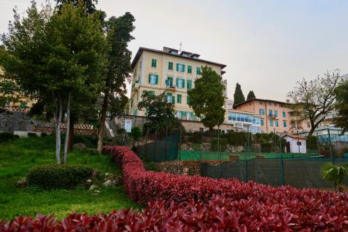 a building with a lot of flowers in front of it at Hotel Lovran in Lovran