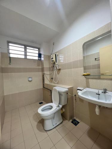 a bathroom with a toilet and a sink at Icon BM Vacation Home with Water Fountain and Barbeque Area by ZamanJa in Bukit Mertajam