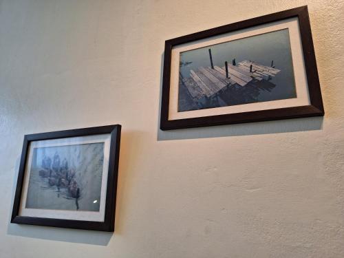 two pictures hanging on a wall at Thaweesuk Heritage Homestay in Phangnga
