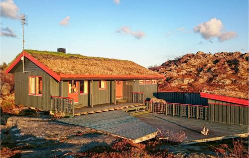 a tiny house with a grass roof on a deck at Beautiful Home In Offersøy With Sauna in Offersøy