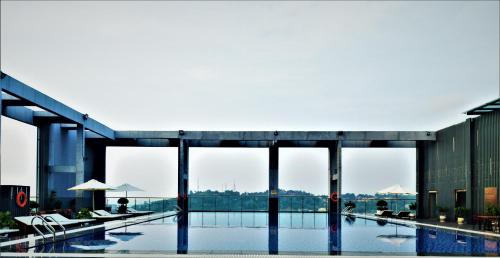 a large swimming pool in a building with windows at Legend Hotel and Resort in Sihanoukville