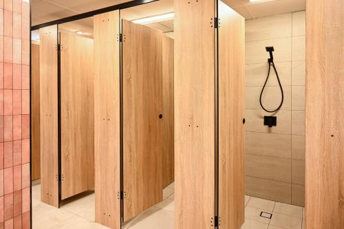 a row of wooden lockers in a bathroom at Nate's Place Backpackers Sydney in Sydney