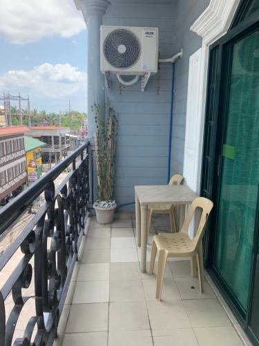 a table and chairs on a balcony with a fan at Bourbon St Apts Condo 30C in Angeles
