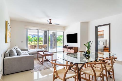 a living room with a table and a couch at Mareazul Beach Front Condos At playa del Carmen in Playa del Carmen