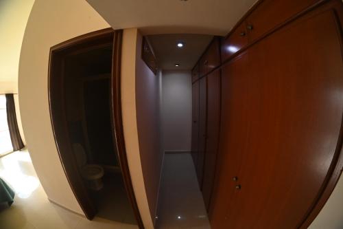 a walk in closet in a room with a door at 14 Comfortable suite for 2 people in Torreón
