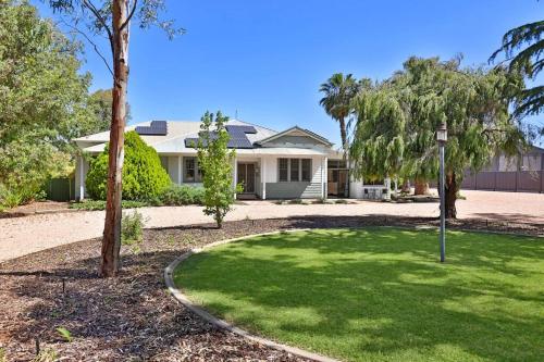 a house with a green lawn in front of it at Kings Billabong Haven in Irymple