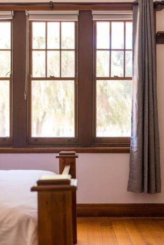 a bedroom with three windows and a bed in it at Kings Billabong Haven in Irymple