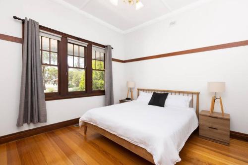 a white bedroom with a bed and a window at Kings Billabong Haven in Irymple