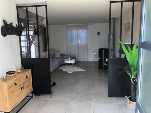 a large living room with a bed and a dresser at Villa Agde très calme in Agde
