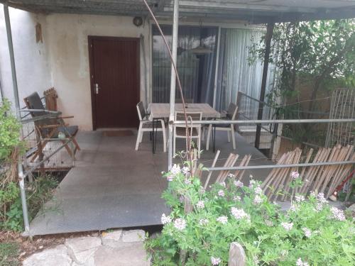 a porch of a house with a table and chairs at הבית בואדי 