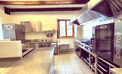 a large kitchen with a large stove top oven at Villa Šumik- Peaceful Hideaway in Ruše