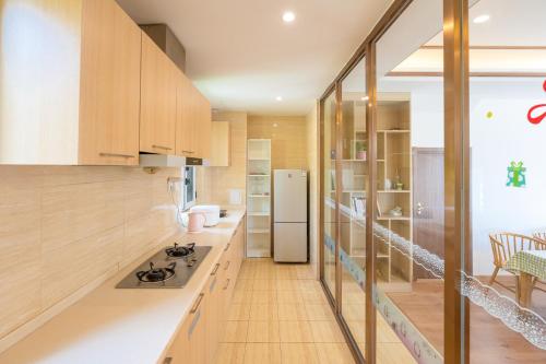 a kitchen with a stove and a refrigerator at Gubei Water Town Landscape Villa in Miyun
