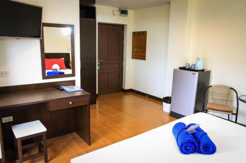 a room with a bed and a desk and a refrigerator at Sky Villa Hua Hin Guesthouse - Adults-Only in Hua Hin