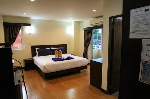 a hotel room with a bed and a window at Sky Villa Hua Hin Guesthouse - Adults-Only in Hua Hin