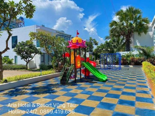 a playground with a slide in a park at Căn hộ biển Aria Vũng Tàu in Xa Thang Nhut