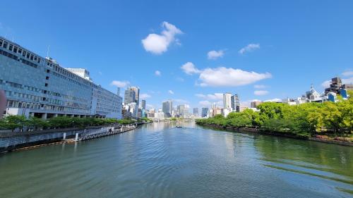 a river with a city in the background at Hotel Osaka Castle in Osaka