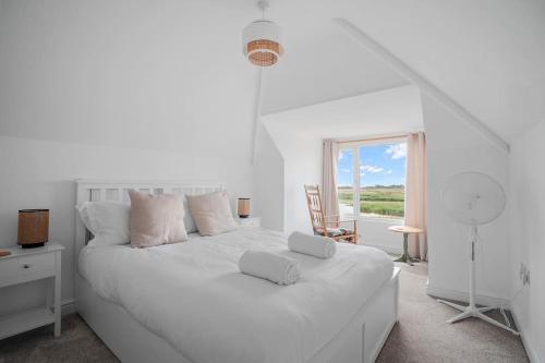 a white bedroom with a white bed and a window at Bay View Luxury Stays - Southdown in Overcombe