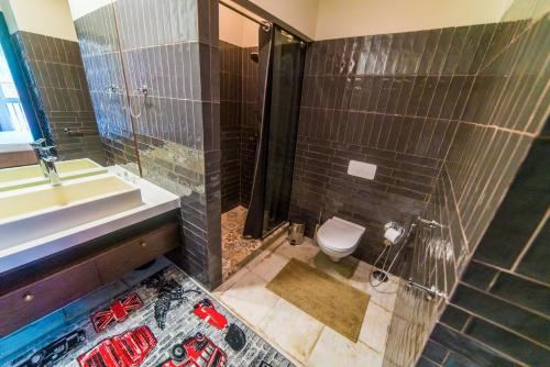 a bathroom with a shower and a toilet and a sink at Manica Esentai City in Almaty