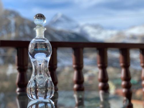 a bottle sitting on top of a rail at Come & Rest in Stepantsminda
