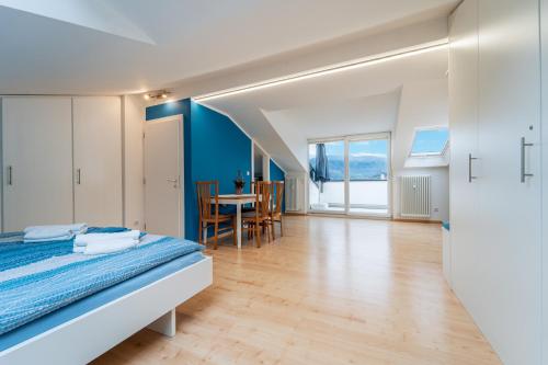 a bedroom with a bed and a dining room at Mias Apartments - #MiasEppan#Badl in Appiano sulla Strada del Vino