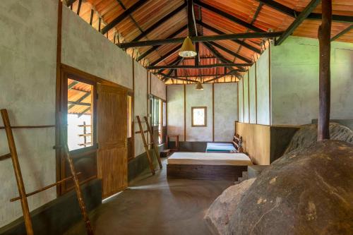 a large room with a bed and a window at The Woods in Haputale