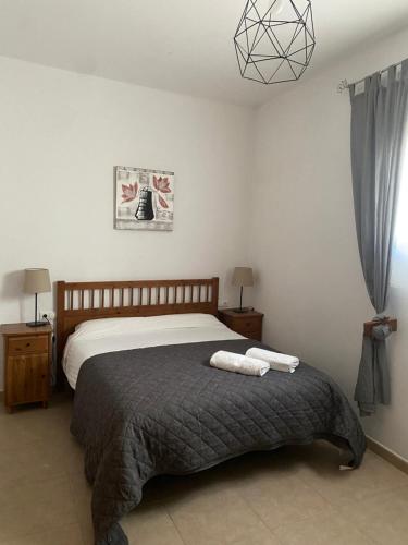a bedroom with a bed with two towels on it at Apartamento Martín in Ardales