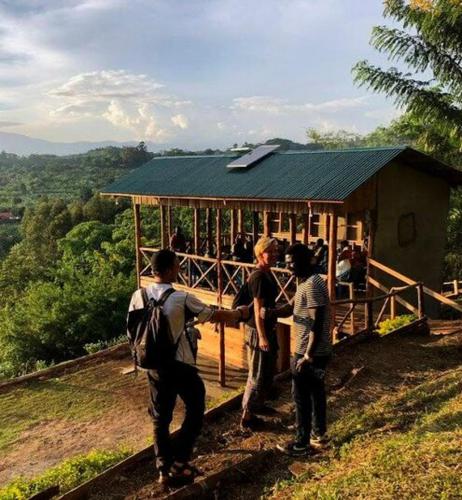 a group of people standing in front of a building at Noah's Ark Campsite & Restaurant in Fort Portal