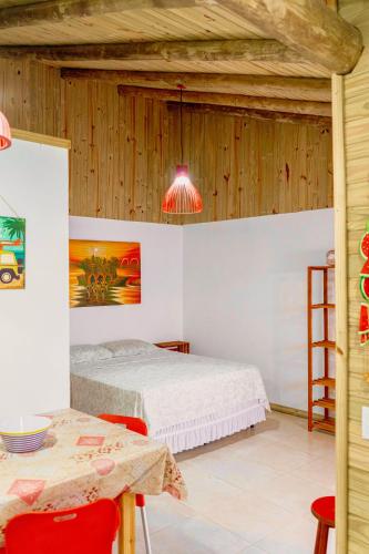 a bedroom with two beds and a table and chairs at CABANAS Villa Del Mar in Farol de Santa Marta