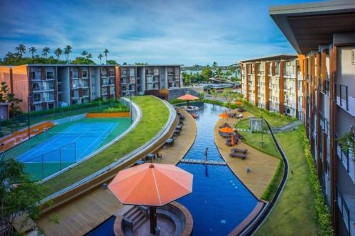 an overhead view of a pool at a resort at Extra large, modern apartment with sea view in Bang Rak Beach