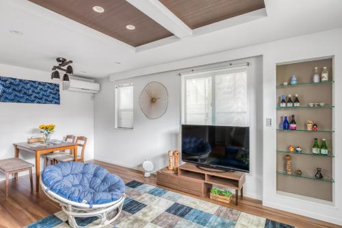 a living room with a blue chair and a tv at self-check in-House,Ueno sky tree area, free wifi 3LDK in Tokyo