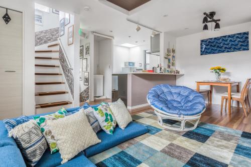 a living room with a blue couch and a table at self-check in-House,Ueno sky tree area, free wifi 3LDK in Tokyo
