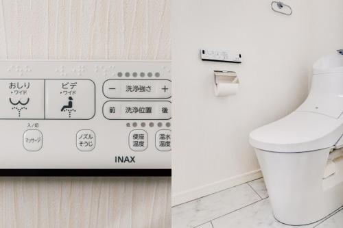 a bathroom with a toilet and a sign on the wall at 92sqm misa,House,Ueno sky tree area, free wifi 3LDK in Tokyo