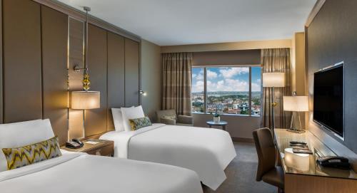 a hotel room with two beds and a television at Renaissance Polat Istanbul Hotel in Istanbul