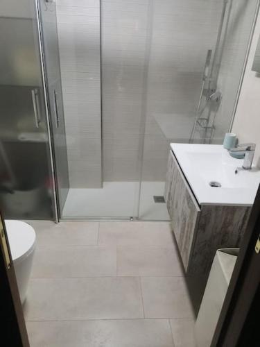 a bathroom with a shower and a toilet and a sink at Piso en la Costilla-Rota in Rota