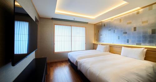 Postel nebo postele na pokoji v ubytování Enoshima Hotel ーEnoshima Island Spa Hotel Buildingー