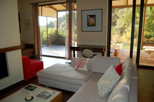 a living room with a white couch and a red chair at Serene retreat in Rhodes Town