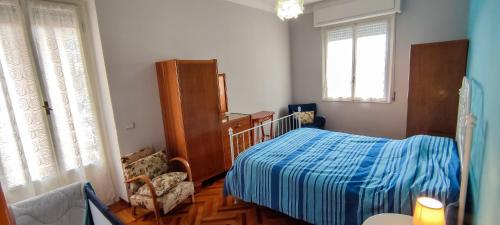 a bedroom with a bed and a chair and window at Le Caravelle in Rapallo