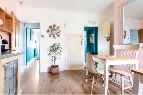 a kitchen and dining room with a table and chairs at Nice bedroom close to the train station and the city centre in Norwich