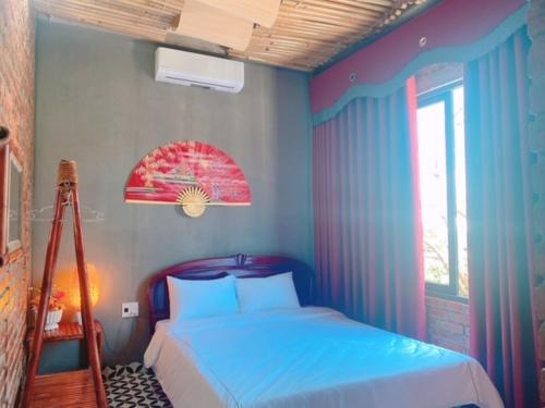 una camera con un letto con pareti blu e una scala di Sunshine villa thuan an a Hue