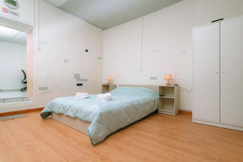 a bedroom with a bed in a room with white walls at Cozy Home Archanes in Archanes