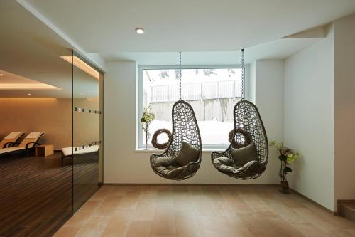 a room with two chairs hanging from a window at Après Post Hotel in Stuben am Arlberg