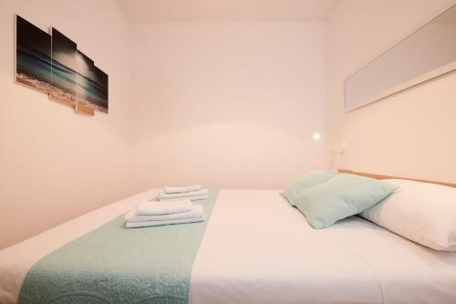 a bedroom with a white bed with towels on it at Apartment Boris in Trogir