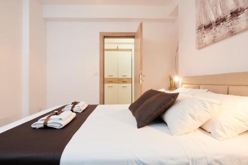 a white bed with two towels on top of it at Apartment Boris in Trogir