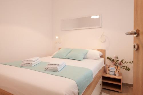 a bedroom with a bed with towels on it at Apartment Boris in Trogir