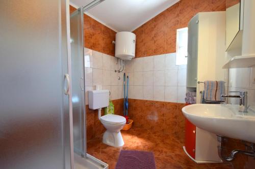 a bathroom with a toilet and a sink and a shower at Holiday Home Pere in Malinska